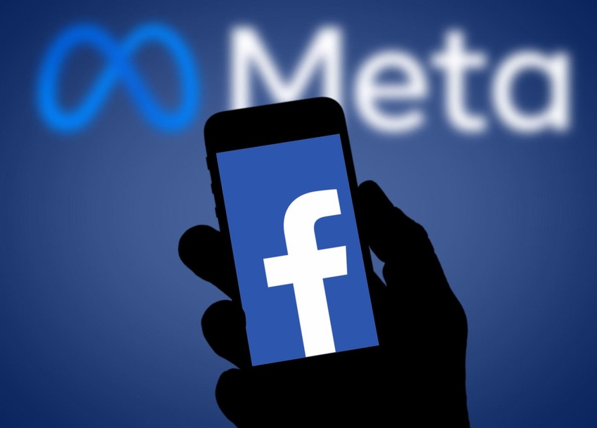 phone showing facebook logo with meta logo in background
