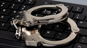 Computer keyboard and handcuffs. Computer keyboard and handcuffs.