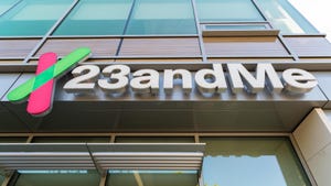 An upward-looking view of the 23andMe logo on a building 