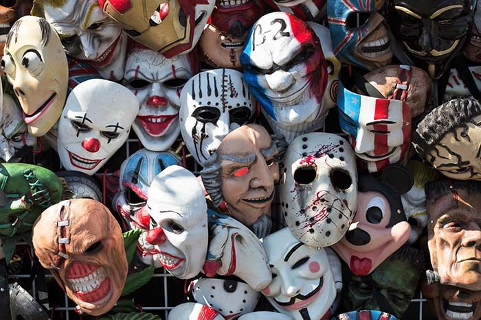 A jumble of scary Halloween masks for sale at the Lane County Fair in Eugene, Oregon, USA.