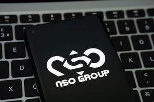 NSO Group logo seen on the smartphone placed on Apple Macbook laptop keyboard