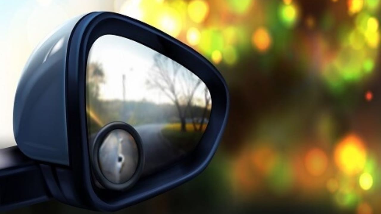 a right rearview mirror with a smaller mirror trying to show the blind spots in the road a right rearview mirror with a smaller mirror trying to show the blind spots in the road