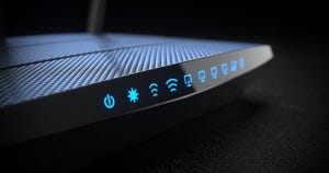 Router with blue lights lighting up various icons across its side