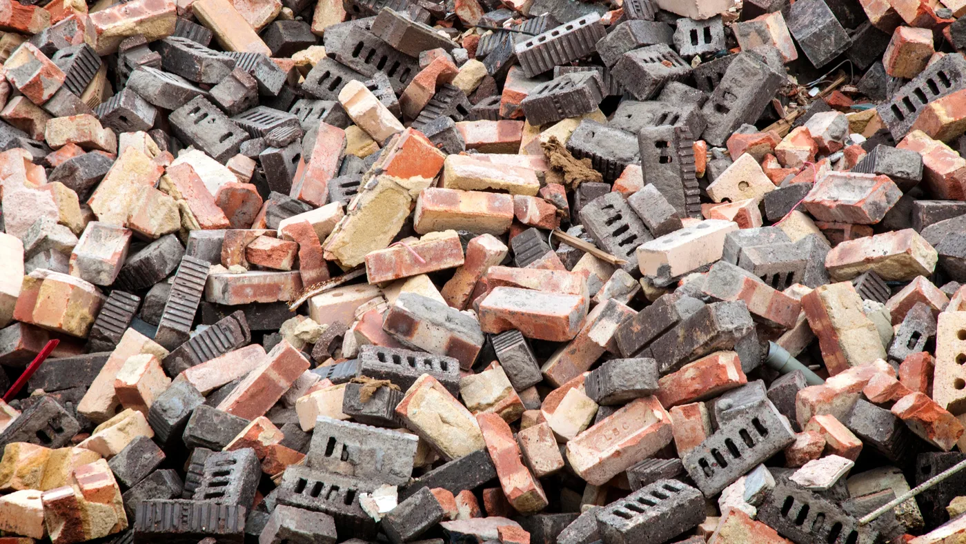A pile of used red and gray bricks A pile of used red and gray bricks