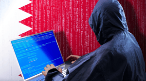 A person in a blue hoodie sitting at a laptop with code on the screen against a red and white backdrop with lines of code on the red part A person in a blue hoodie sitting at a laptop with code on the screen against a red and white backdrop with lines of code on the red part