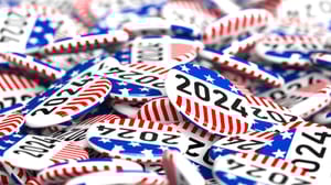 A pile of 2024 red, white, and blue, election buttons A pile of 2024 red, white, and blue, election buttons