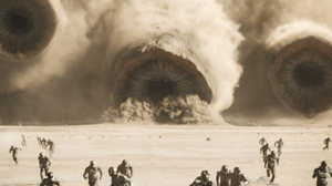 Sandworms from the film Dune chasing a group of fleeing people across the sand Sandworms from the film Dune chasing a group of fleeing people across the sand