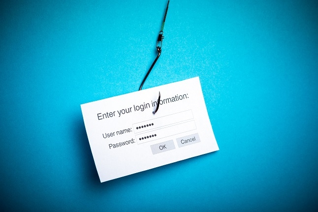Fishing hook snagging a piece of paper saying "enter your login credentials"