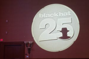 Photo of the Black Hat 25 logo projected on a conference room wall