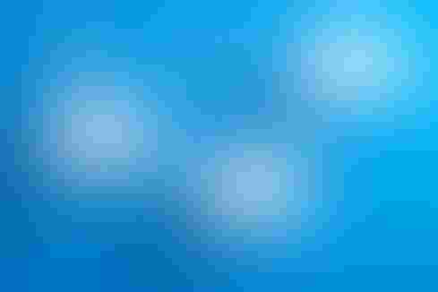 Illustration of a cluster of cartoony clouds hanging on a blue wall. The clouds have little eyes.