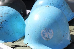 Four blue UN peacekeeper helmets 
