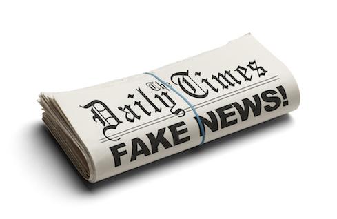 A newspaper that reads "The Daily Times" with a headline that says "Fake News"