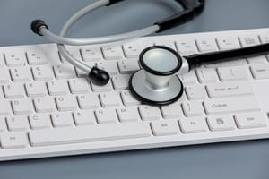 a stethoscope on top of a white keyboard a stethoscope on top of a white keyboard