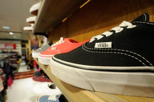 Rows of Vans shoes at a retail outlet