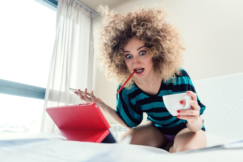 Panicked woman looking at her laptop
