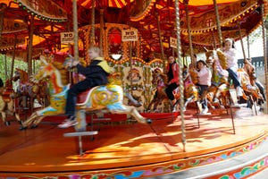 Child on a vintage merry-go-round horse Child on a vintage merry-go-round horse