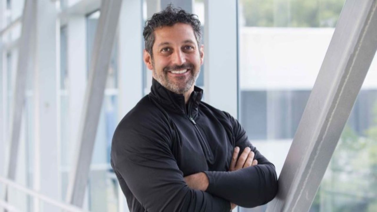 Amit Yoran in a dark sweater standing in front of a window Amit Yoran in a dark sweater standing in front of a window