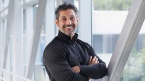 Amit Yoran in a dark sweater standing in front of a window Amit Yoran in a dark sweater standing in front of a window