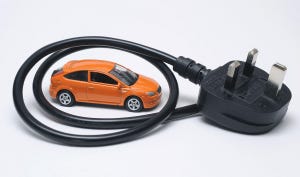 Car encircled by an electrical cord and plug