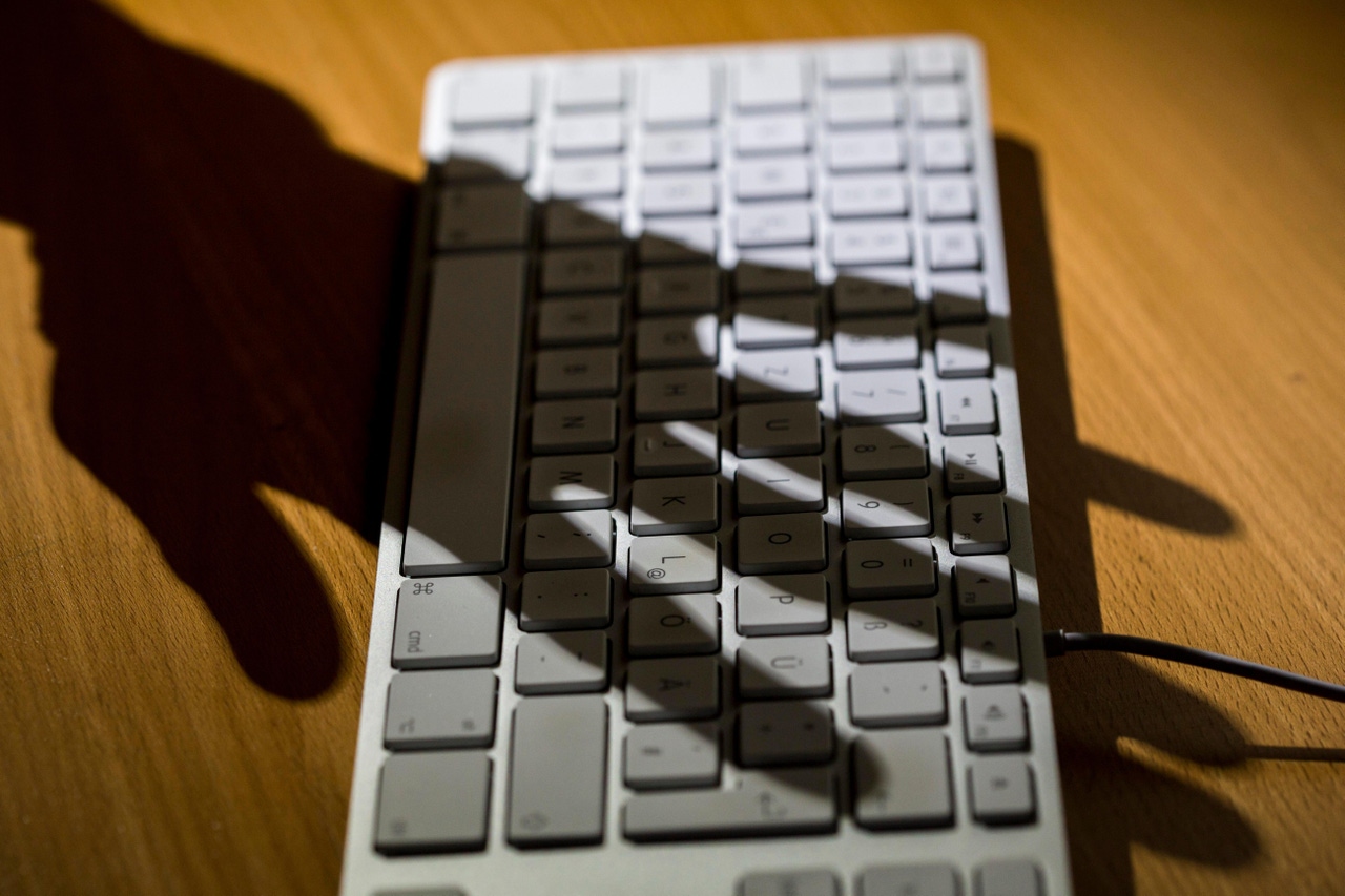 Shadow of a hand over a keyboard Shadow of a hand over a keyboard
