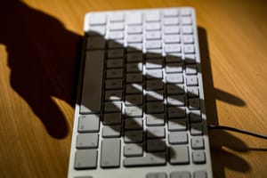 Shadow of a hand over a keyboard Shadow of a hand over a keyboard