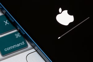 Closeup up of the Apple logo and progress bar seen on an iPhone when the iOS firmware is being updated
