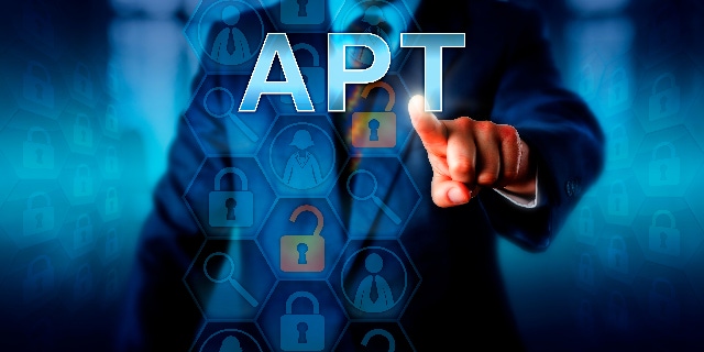 Image contains a man in a suit from the neck down pointing a finger at the letters "APT."