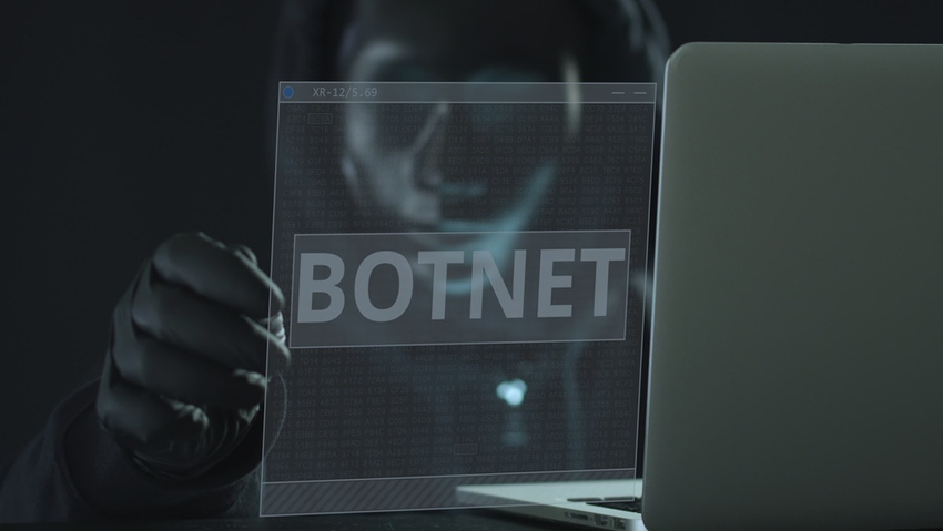 A hacker wearing black pulls BOTNET tab from a laptop. Hacking concept