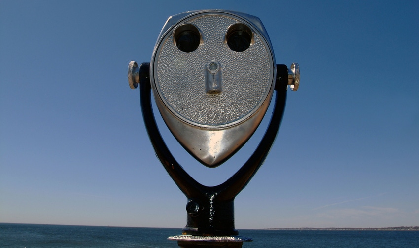 Coin operated binoculars; blue sky behind it
