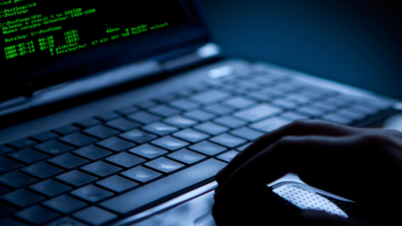 Hacker using laptop with green code on the screen Hacker using laptop with green code on the screen