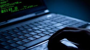 Hacker using laptop with green code on the screen Hacker using laptop with green code on the screen