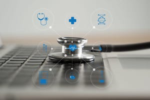A stethoscope on a keyboard with health symbols above it