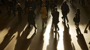 Businesspeople cast long shadows during morning rush hour inside Grand Central Station