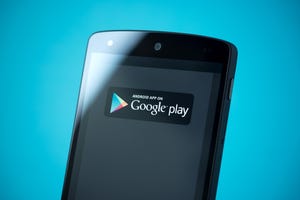 Black mobile device with the logo for the Google Play store displayed on the screen