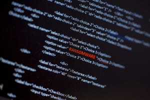 Code on a screen with the word "Ransomware" in red