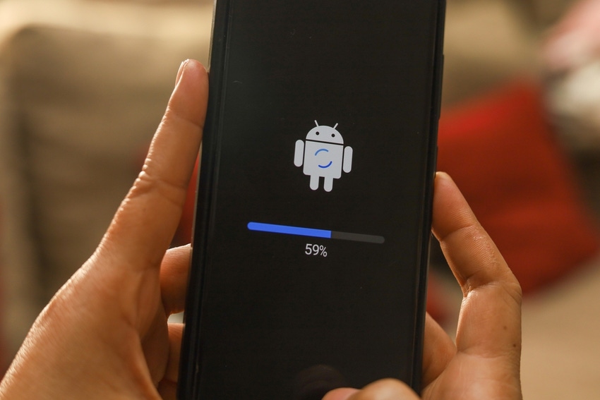 Two hands holding a mobile device with the Android logo, a blue and gray bar, and 59% shown on the screen