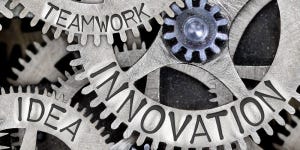 Photo illustration of meshing gears with the words innovation, idea, and teamwork stamped on them  