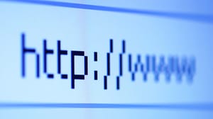 A close-up of the domain name in the search bar on a monitor or laptop screen A close-up of the domain name in the search bar on a monitor or laptop screen