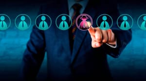 A person in a suit trying to identify one problematic employee out of a group A person in a suit trying to identify one problematic employee out of a group