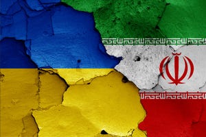 Flags of Ukraine and Iran on a cracked wall