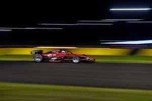 a race car on a track against a blurred background a race car on a track against a blurred background