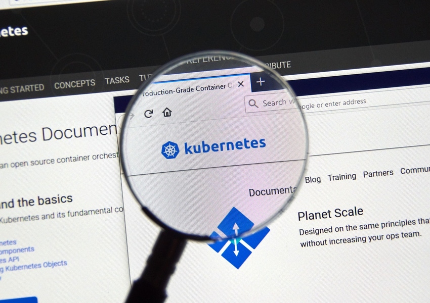 a magnifying glass on the Web logo of Kubernetes