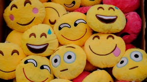 Various emoji faces on pillows