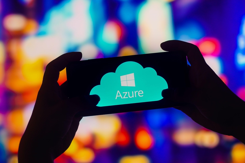 Image shows silhouetted hands holding a smartphone with the word and logo for "Azure" on the screen against multicolor backdrop