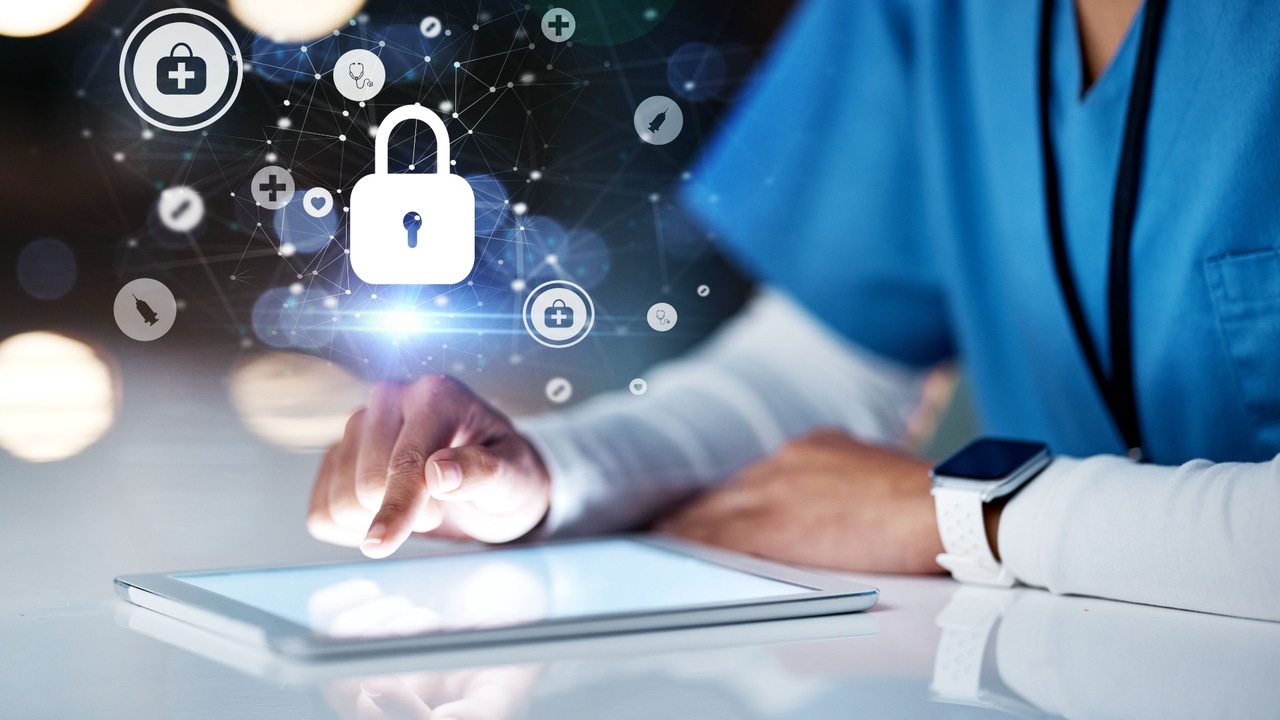 A person in medical scrubs working on a tablet computer A person in medical scrubs working on a tablet computer