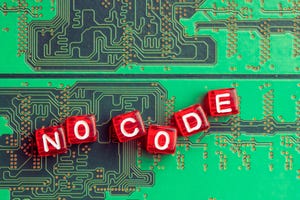 Red tiles with white lettering spells out the words "No code" against a green circuit board.
