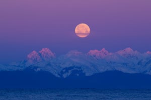 Full moon against Chilkat Mountains and Lynn Canal in Southeast Alaska