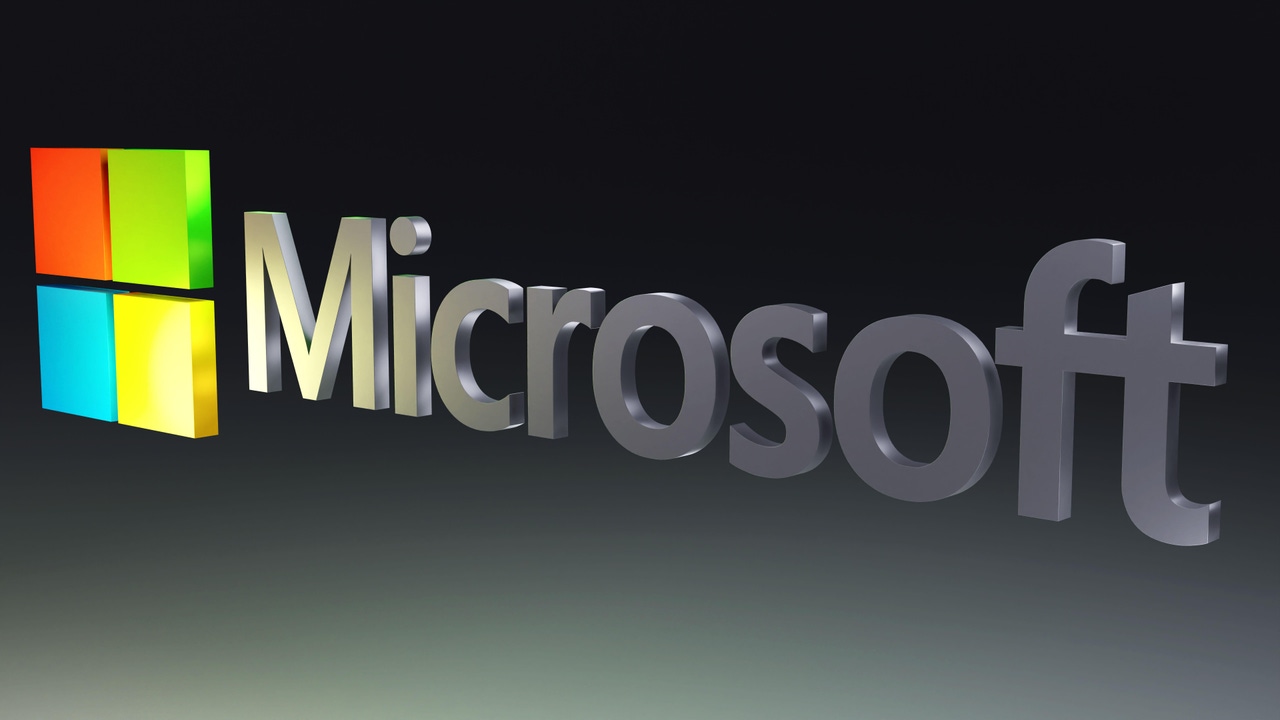 Microsoft logo on top of a black and grey background Microsoft logo on top of a black and grey background