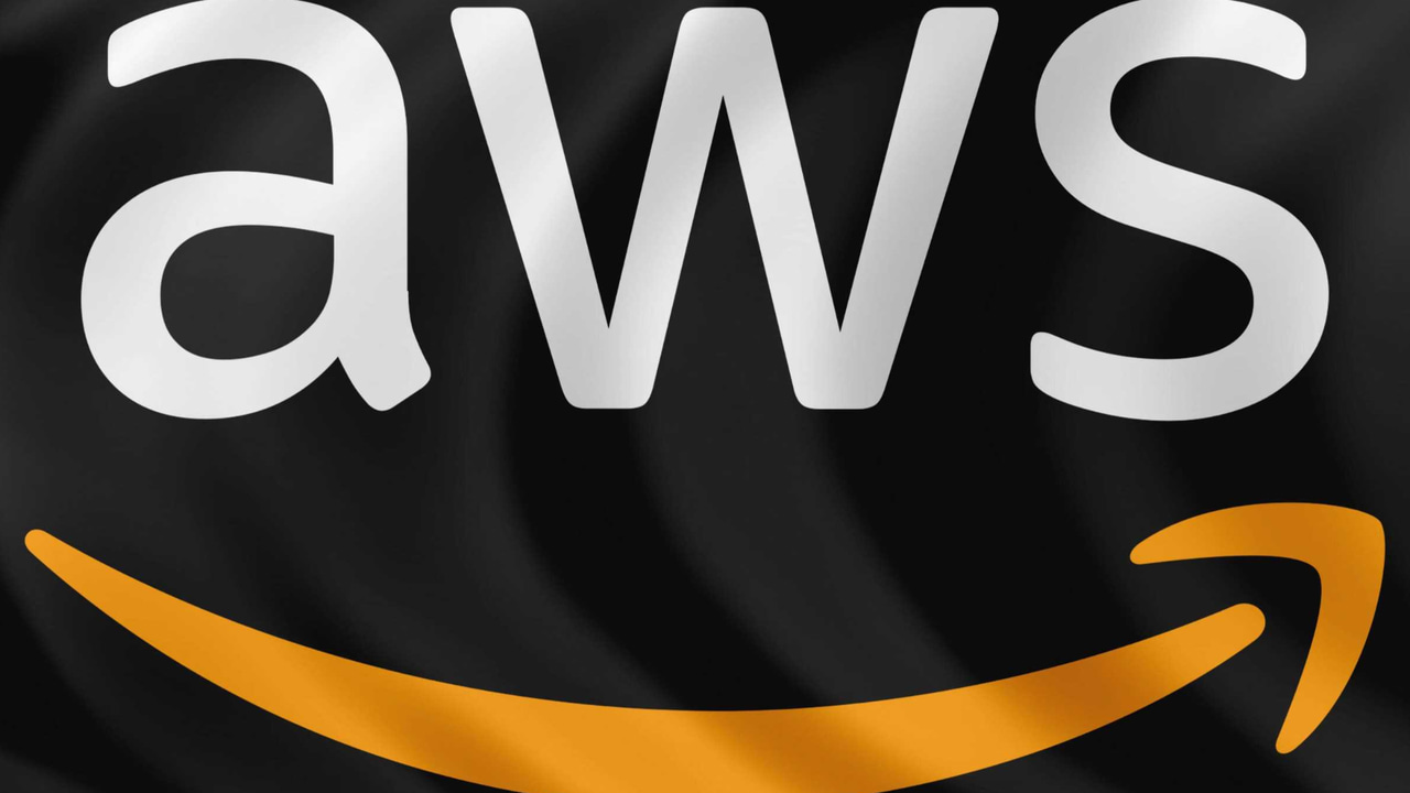 Letters AWS in white with a yellow arrow pointing to the right underneath against a black backdrop Letters AWS in white with a yellow arrow pointing to the right underneath against a black backdrop