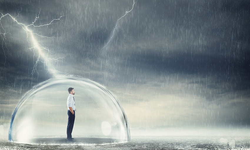 Photo illustration of a businessman surrounded by a protective dome as rain and lightning rage
